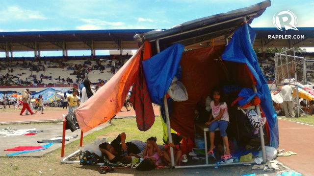 MAKESHIFT HOME. A girl sits under the canopy of her temporary shelter at the Joaquin Enriquez Memorial Grandstand in Zamboanga City on Sept 11, 2013. Photo by Regine Mendoza/Rappler