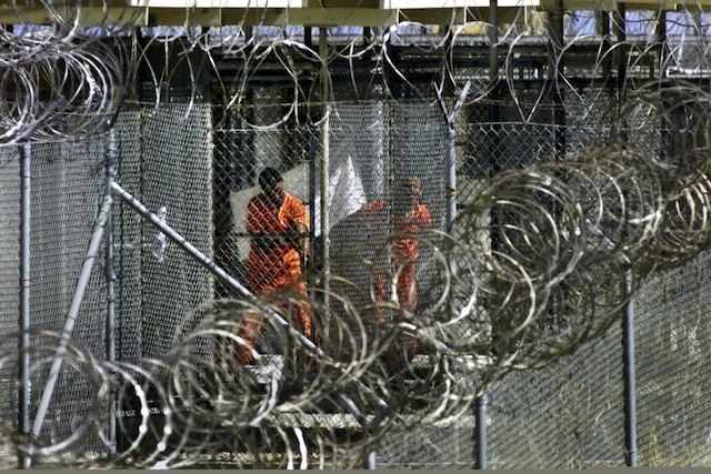 DETAINED. A file photograph showing men dressed in orange coveralls, alleged al-Qaida and Taliban combatants captured in Afghanistan washing before midday prayers at controversial Camp X-Ray, where they are being held in cages at the US Naval Base at Guantanamo Bay, Cuba, 27 January 2002. Photo by  EPA/J. Scott Applewhite / Pool