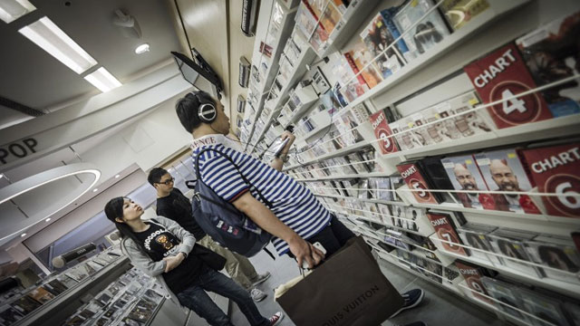 In a picture taken on June 17, 2012, customers browse for music CDs in a shop in Hong Kong. AFP PHOTO / Philippe Lopez