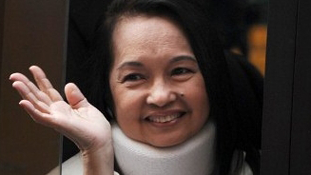 Former President Gloria Macapagal-Arroyo, who marks her first birthday under arrest, waves to the media after filing a "not guilty" plea in relation to alleged electoral sabotage last February. AFP/Ted Aljibe
