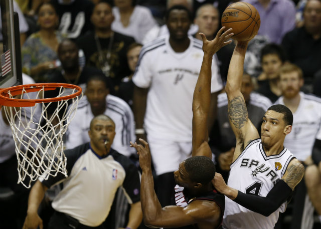 SIDELINED. San Antonio Spurs player Danny Green, shown shooting over Chris Bosh in last year's NBA Finals, is out for four weeks with a broken finger. Photo by Aaron M. Sprecher/EPA