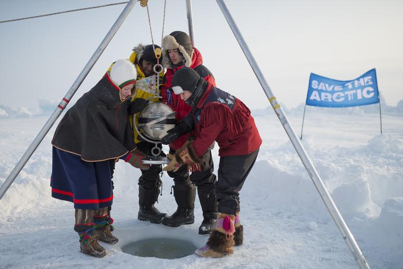 Team Aurora (L-R) Josefina Skerk, Renny Bijoux, Ezra Miller, and Kiera Dawn Kolson prepare to lower the time capsule into the icy waters at the North Pole. Photo by Christian Åslund / Greenpeace
