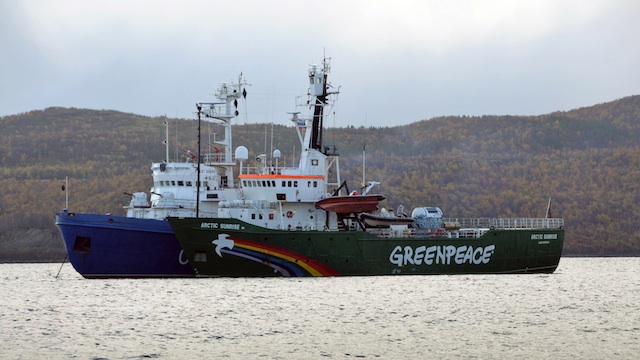 SEIZED. The seized Greenpeace ice breaker 'Arctic Sunrise' (front) is towed by a Russian Coast Guard vessel (behind) along the Kola Bay of the Barents Sea, some 40 kilometers from Murmansk, Russia, 24 September 2013. EPA/Angela Kolyada