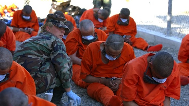 US soldier watches detainees at Guantanamo. Photo courtesy of Amnesty International