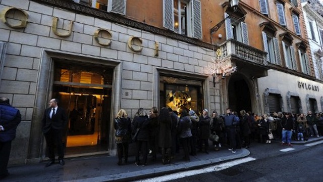 People queue as they wait for the opening of a Gucci luxury goods shop on the first day of the winter sales in Via dei Condotti in Rome. AFP PHOTO / GABRIEL BOUYS
