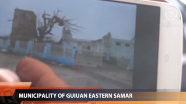 RUINS. Solar TV reporter David Santos shows a photo of the destruction in Guiuan, Eastern Samar.