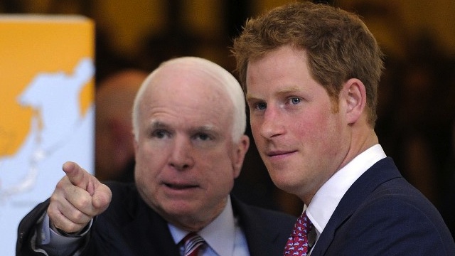 LANDMINE TALK. In this file photo, Britain's Prince Harry (R) is accompanied by US Senator John McCain as he tours a Senate photo exhibit on landmines and unexploded ordnances in the Rotunda of Russell Senate Office Building in Washington, DC, on May 9, 2013. AFP PHOTO/Jewel Samad