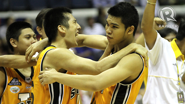 TIGERS CELEBRATE. Jeric Teng and Aljon Mariano share a hug after their victory over Ateneo 71-70. July 19, 2012. Josh Albelda.