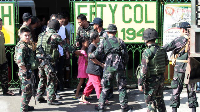 FREE. Hostages leave Southern City Colleges onto a waiting vehicle that will take them to camp batalla for processing. Photo by Leanne Jazul/Rappler
