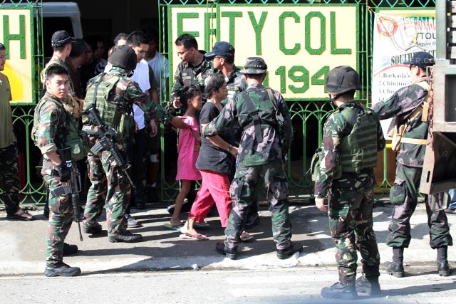 HOSTAGES. Soldiers assist rescued hostages to a waiting vehicle taking them to Camp Batalla for processing. Photo by Rappler