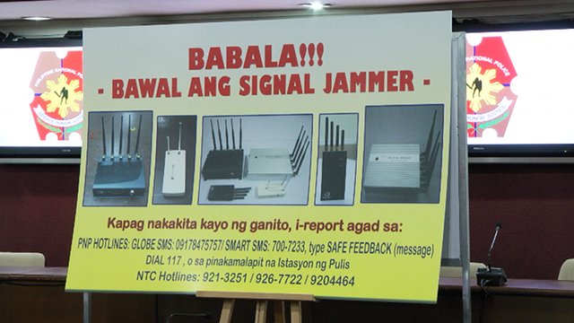 WARNING. A poster asking the public to report sightings of signal jammers, including the numbers they can call or text. Photo by Rappler/Naoki Mengua