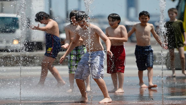 COOLING DOWN. Children play in a water fountain along the Greenway as high levels of humidity and temperatures approached 95ºF (35ºC) in Boston, Massachusetts, USA 31 May 2013. EPA/CJ Gunther