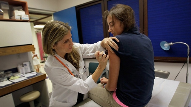 HPV VACCINATION. University of Miami pediatrician Judith L. Schaechter, M.D. (L) gives an HPV vaccination to a 13-year-old girl in her office at the Miller School of Medicine on September 21, 2011 in Miami, Florida. The vaccine for human papillomavirus, or HPV, is given to prevent a sexually transmitted infection that can cause cancer. File photo by Joe Raedle/Getty Images/AFP