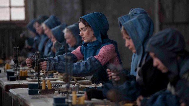 'THIS PAIN LIVES IN THIS WORLD.' Anne Hathaway works like a slave in one of the film's scenes. Photo from the movie's Facebook page