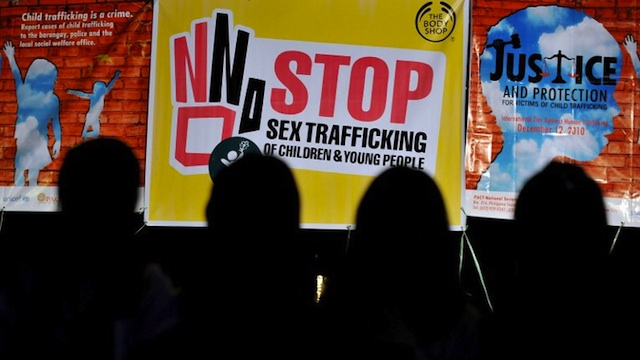 TRAFFICKING ON THE RISE Children are silhouetted in front of posters displayed during a prayer for Justice and Protection against Sex Trafficking of Children and Young People in Quezon City suburban Manila on December 12, 2010, as part of the annual observance of International Day against Human Trafficking. AFP Photo/Jay Directo 