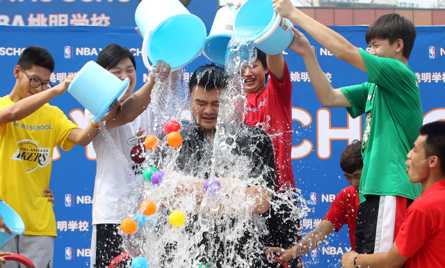GLOBAL TREND. A handout photograph released by NBA Yao School shows former NBA star Yao Ming being doused with ice water in an 'ice bucket challenge' during a graduation ceremony for students of his NBA Yao school in Beijing, China on August 23, 2014. Photo by NBA Yao School/EPA