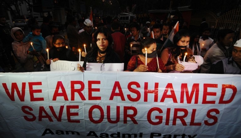 SAVE OUR GIRLS. In this photograph taken on December 29, 2012, Indian protestors march behind a banner as they take part in a candlelight procession in Guwahati, after the death of a gang-rape victim from the Indian capital New Delhi. AFP/Stringer