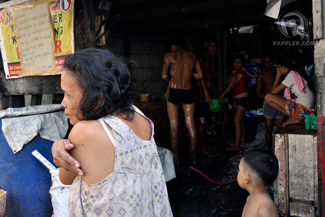 REFRESHED. Intramuros residents escape the afternoon heat the old-fashioned way