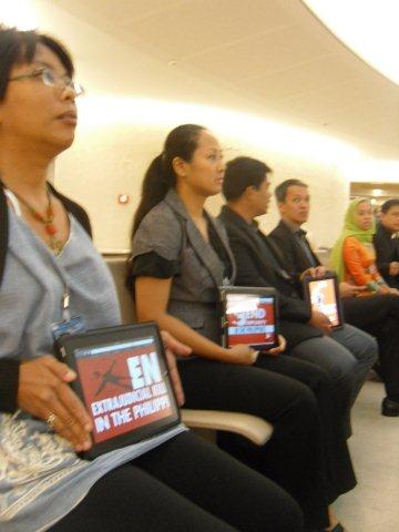 END EXTRAJUDICIAL KILLINGS. Activist members of the Philippine UPR Watch hold silent protest on the sidelines of the UN human rights review, flashing their iPads as placards. Photo by the Philippine UPR Watch 