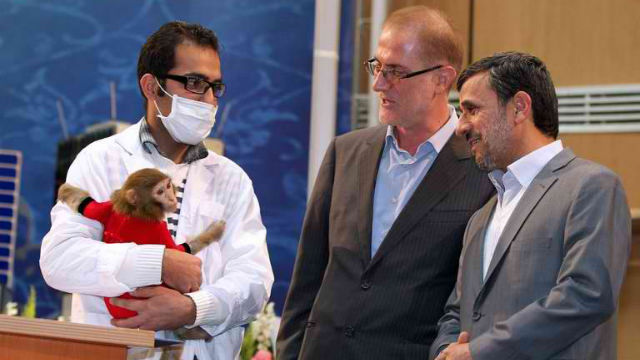 MONKEY TO SPACE. A handout picture released by the Iranian presidency website shows President Mahmoud Ahmadinejad looking at a space monkey during a ceremony to mark Iran's National Day of Space Technology in Tehran. AFP Photo