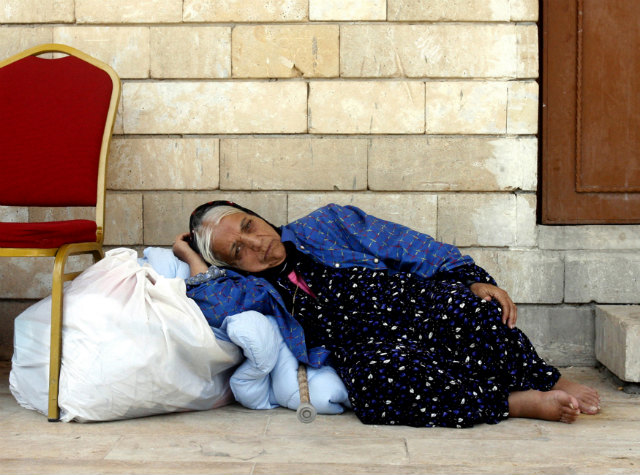 FEAR OF PERSECUTION. An Iraqi Christian woman forced to flee her home shelters in the St Joseph Church in Erbil, northern Iraq, on August 9, 2014. Photo by Mohammed Jalil/EPA
