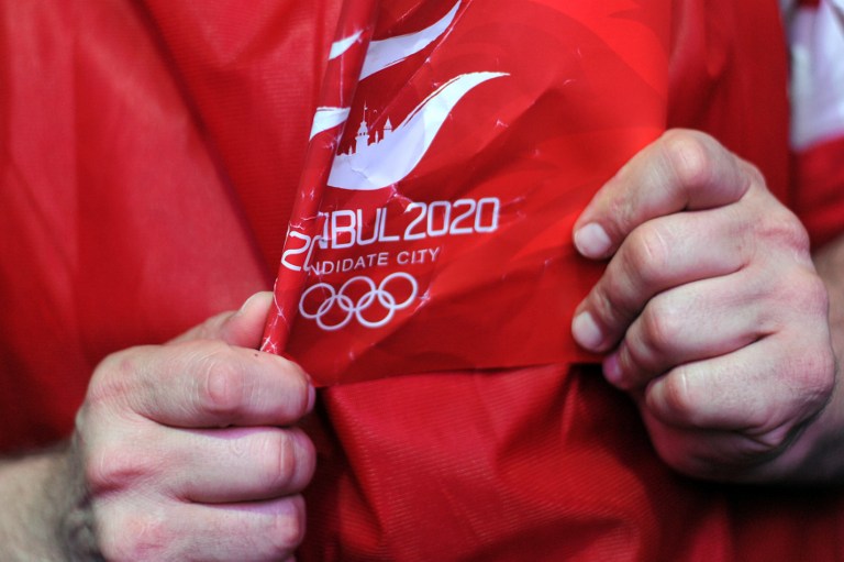 LOSING 2020. A man holds a flag of Istanbul 2020 after the IOC announced Tokyo the winner of the Summer Olympic Games on September 7, 2013, at Sultanahmet Square in Istanbul. AFP / Ozan Kose