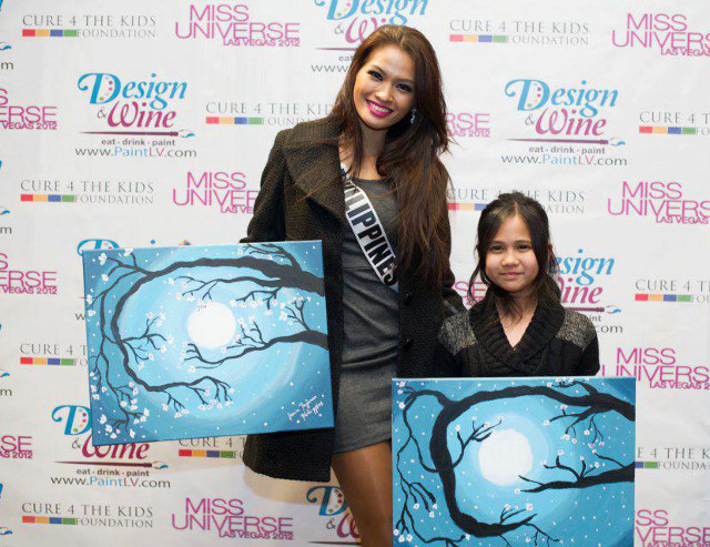 CARING BEAUTY QUEEN. Miss Philippines Janine Tugonon and Maria pose with their artwork. Photo posted on the Janine Mari Raymundo Tugonon Facebook page