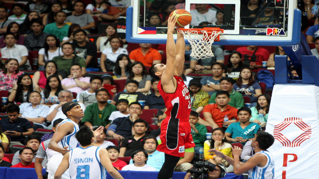 HANGING ON. Japeth Aguilar of Barangay Ginebra throws down 2 of his 26 points in a losing effort against the San Mig Coffee Mixers Sunday night. Photo by KC Cruz/PBA Images