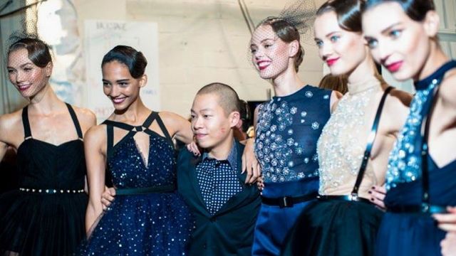 JASON WU WITH SOME of his models in a candid backstage photo taken by Vogue.com and posted in the designer's Facebook page