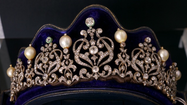 CULTURED PEARL AND DIAMOND TIARA by British designer Catchpole & Williams designed as five circular-cut diamond motifs intersected by a cultured pearl and diamond motif, mounted in silver & gold, in a blue leather fitted case. $20,000-25,000. All photos courtesy of PCGG