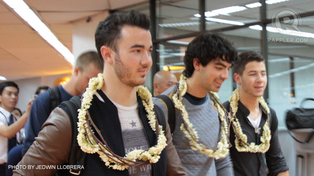 NICK, JOE AND KEVIN upon their arrival at the Manila International Airport for their first-ever Manila concert. Photo by Jedwin Llobrera