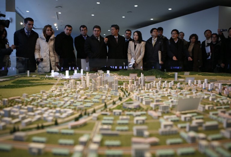 VISITING KAESONG. The G20 Seoul Conference delegation look at a miniature model of the Kaesong Industrial Complex (KIC) at the Kaesong Industrial District Management Committee in Kaesong on December 19, 2013. AFP / Pool / Kim Hong-Ji