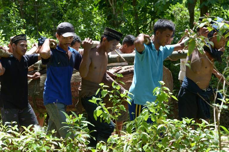 VILLAGERS AT WORK. This picture taken on August 12, 2013 shows Kajang men carrying a log used to build a house at Amatoa village where the Kajang tribe live in Bulukumba, South Sulawesi. Adek Berry/AFP