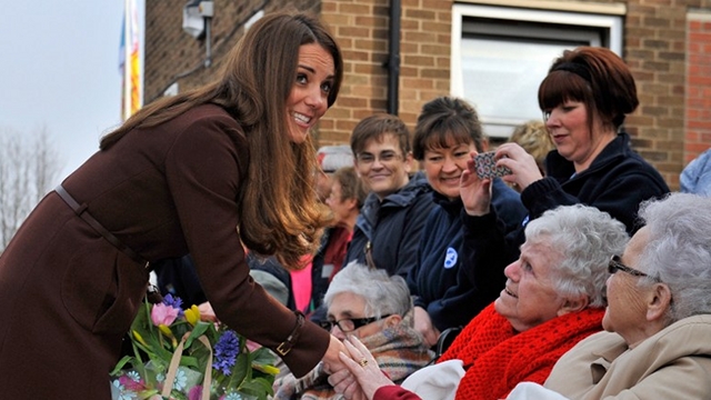 Britain's Catherine, Duchess of Cambridge (L) meets residents of nearby St Andrews Hospice as she visits the Peaks Lane Humberside Fire and Rescue Station in Grimsby, northeast England, on March 5, 2013. The Duchess of Cambridge was on an official visit to Grimsby during which she visited the National Fishing Heritage Centre, the Peaks Lane Fire Station and the Havelock Academy. AFP PHOTO / POOL / BRUCE ADAMS