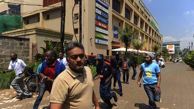 MALL ATTACK. People run away from an upmarket mall after masked gunmen stormed it and sprayed gunfire on shoppers and staff on September 21, 2013 in Nairobi. AFP/Simon Maina