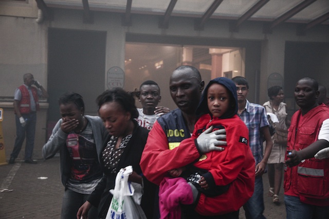 ESCAPE FROM DANGER. People escape from the fire allegedly started by gunmen inside of the Westgate shopping mall after a shootout in Nairobi, Kenya, 21 September 2013. EPA/Kabir Dhanji