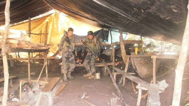 CAPTURED. Military forces inspect the area that served as the kitchen in the camp. Photo from Police Regional Office-Cordillera