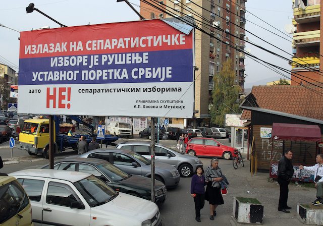 BEFORE THE POLLS. Kosovar Serbs are passing by Serbian-colored campaign posters prior to local elections in Kosovo, in the northern part of ethnically divided town of Mitrovica, Kosovo, 01 November 2013. EPA/Djordje Savic