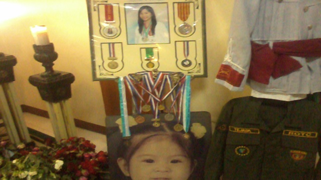 MEMENTOS. Displayed at Kristel's wake are her medals and ROTC uniform. Photo by Buena Bernal