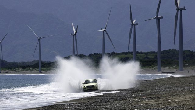 THE LAND ROVER EVOQUE enjoys a splash while the Bangui wind mills tower in the background