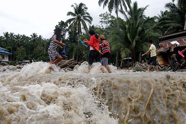 NOT PASSABLE. 33 roads and bridges are presently not passable making the search and rescue operations harder for the emergency responders. Photo by EPA/Ritchie Tiongco