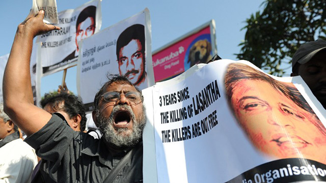 MEDIA RIGHTS. A Sri Lankan Media Rights activist holds a poster of journalist Lasantha Wickrematunge shot dead in 2009 in Colombo, as part of a demonstration in January 2012 in Colombo. Photo by Ishara S Kodikara/Agence France-Presse