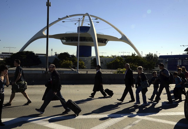 TO SAFETY. Passengers are evacuated from Los Angeles International Airport after a suspected shooter opened fire in Terminal Three at Los Angeles, California, USA 01 November 2013. EPA/Michael Nelson