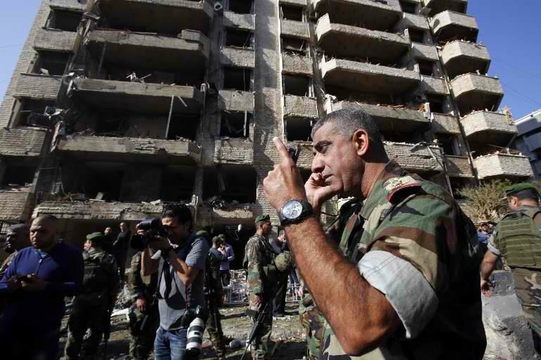BLAST ZONE. A member of the Lebanese army talks on the phone at the site of a blast in Bir Hassan neighborhood in southern Beirut on November 19, 2013. AFP/Anwar Amro