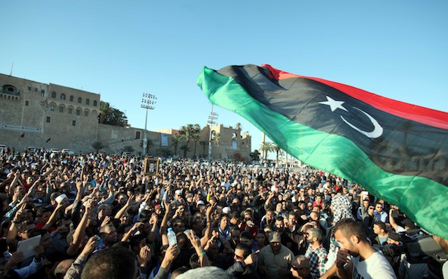 PROTESTS. Libyans wave the national flag and shout slogans as they attend the funeral of protesters killed during a demonstration in Tripoli, Libya, 16 November 2013. EPA/Sabri Elmhedwi