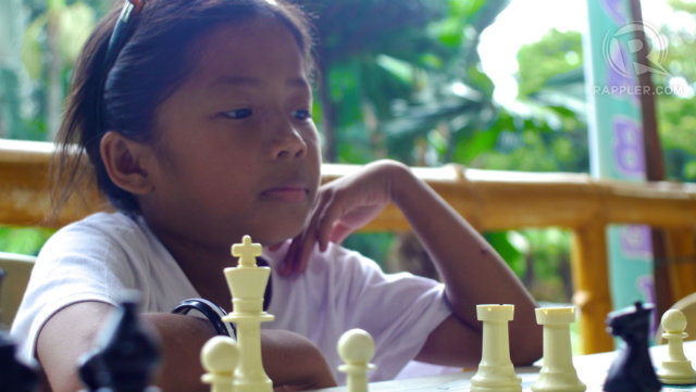 MAKING HER MOVE. Little Ruth Vinuya is the youngest chess player in Palaro 2013. Photo by Devon Wong