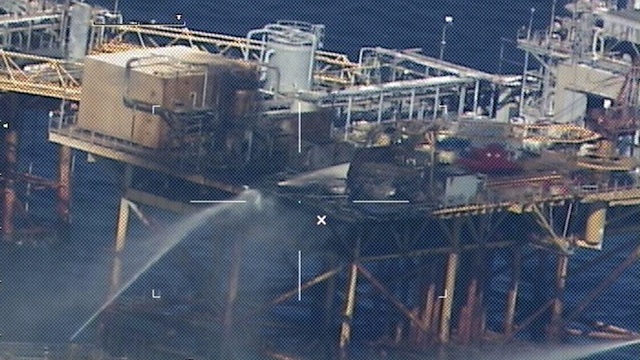 DEADLY BLAST. Commercial vessels spray water to extinguish a platform fire on board the West Delta 32 oil rig in the Gulf of Mexico off Grand Isle, Louisiana on November 16, 2012. AFP PHOTO / HNADOUT / US COAST GUARD