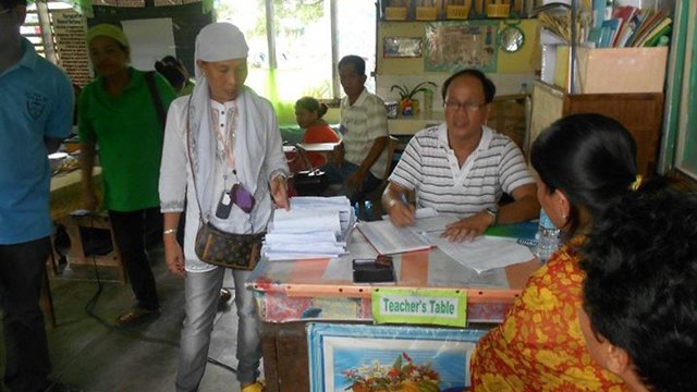 REGISTRATION. An election officer assists registrants in a school in Maguindanao. Photo from LENTE