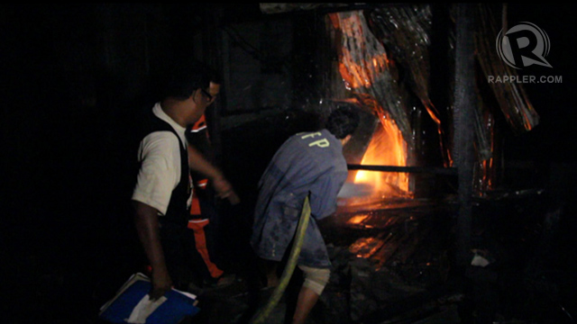 FIGHTING FIRE. Firemen attempt to put out a blaze in the Maguindanao HQ of the Liberal Party.   
