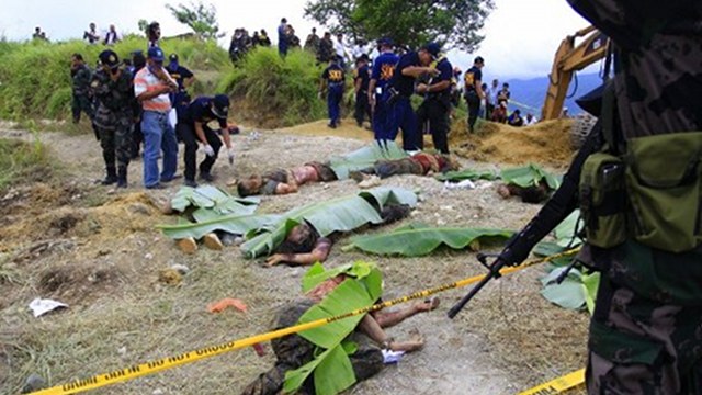MURDER CHARGE #58. Police investigators looking at dead bodies covered with banana leaves, victims of the massacre in the town of Ampatuan, Maguindanao province. File photo from AFP